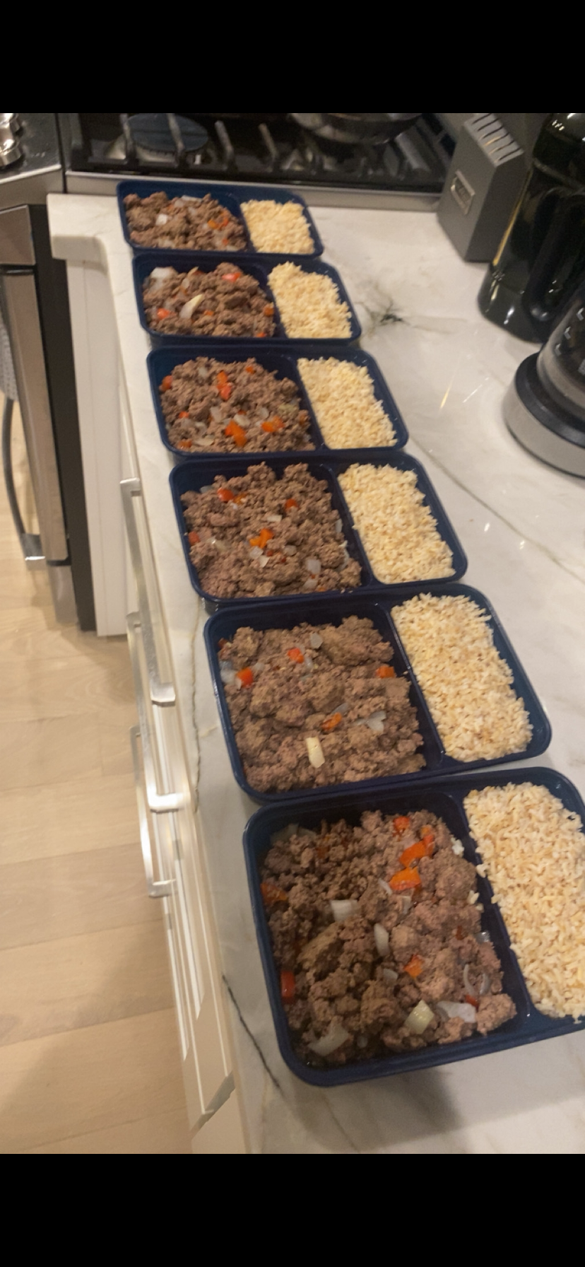 Row of prepped meals with beef and rice